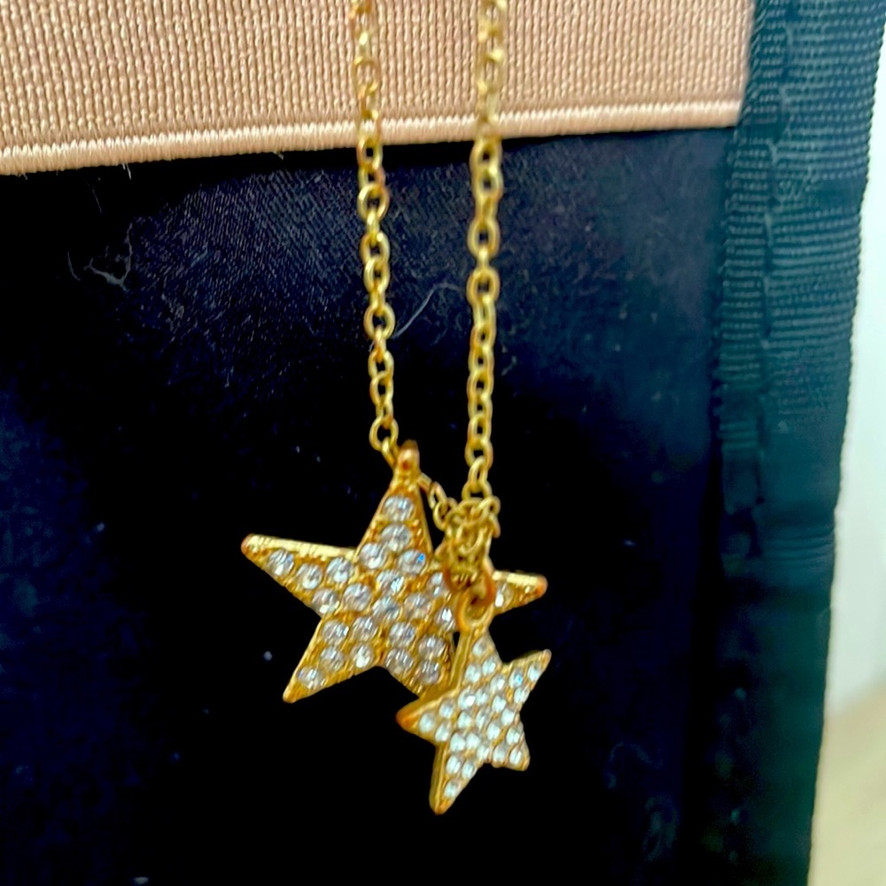 Gold-colored dual star necklace.